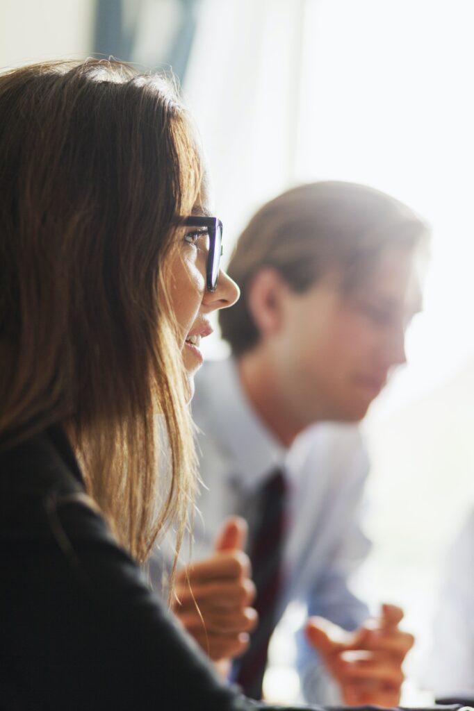 Close-up of woman and man at business meeting